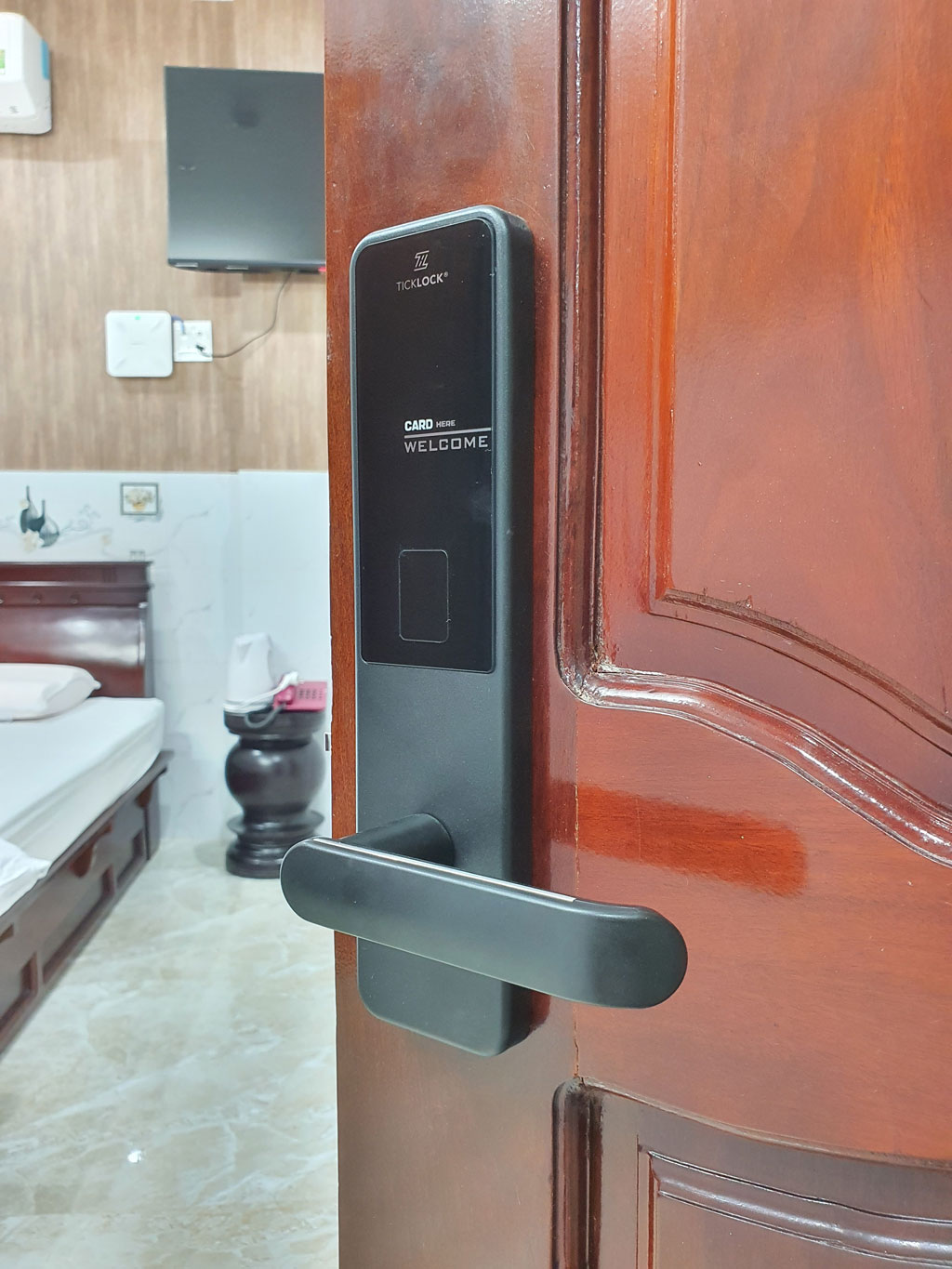 Bộ TICKLOCK SK600 lắp trên cánh cửa gỗ của một phòng lưu trú